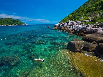 Woman swimming in the crystal sea Koh TaoSuratthani Thailand