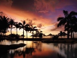 Sunset over swimming pool at Shangri-La Rasa Ria Resort