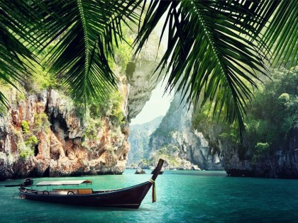 Long boat and rocks on beach in Krabi, Thailand