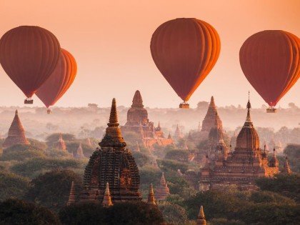 Hot air balloon over plain of Bagan in misty morning, Myanmar