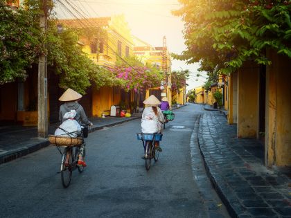 Woman Vietnam riding bicycle on during sunset in Hoi An
